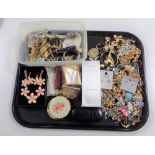 A tray of assorted costume jewellery, lady's watches, Calvin Klein perfume,