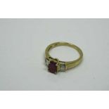 A 10ct gold ruby and diamond ring, the central ruby approximately 1ct, 2.6g, size N.