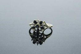 A 10ct gold diamond and sapphire cluster ring, 2.8g, size N/O.