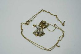 A yellow two-tone gold pedant modelled as an angel on chain