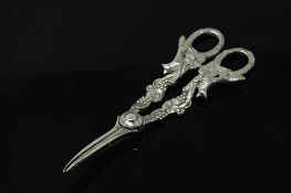 A very ornate pair of silver grape scissors depicting foxes.