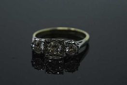 An 18ct gold three stone diamond ring, the three brilliant cut stones approximately 1ct,