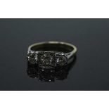 An 18ct gold three stone diamond ring, the three brilliant cut stones approximately 1ct,