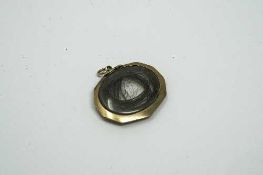 A Victorian mourning locket with hair insert.