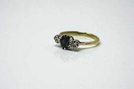 An 18ct yellow gold three stone diamond and sapphire ring, approximately 0.4ct, size O/P.