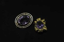 Two antique yellow metal brooches (lacking pins) mounted with amethysts.