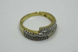 An 18ct yellow gold diamond ring set with baguette and round cut diamonds, size L/M.