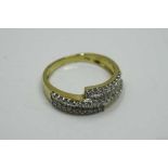 An 18ct yellow gold diamond ring set with baguette and round cut diamonds, size L/M.