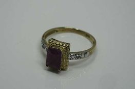 A 10ct gold emerald cut ruby and diamond ring, the ruby measures 7 mm x 5 mm, size M/N.