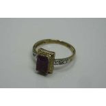 A 10ct gold emerald cut ruby and diamond ring, the ruby measures 7 mm x 5 mm, size M/N.