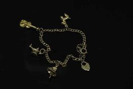 A 9ct gold bracelet with three 9ct gold charms, 10.4g gross.