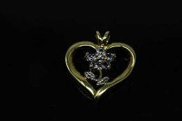 A 10ct gold tanzanite and diamond heart pendant, the five round tanzanite stones approximately 0.