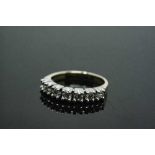 An 18ct white gold seven stone diamond half eternity ring, approximately 0.7ct, size P.