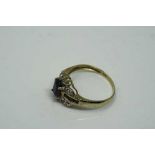 A 10ct yellow gold sapphire and diamond ring, sapphire measures 6 mm x 4 mm, size N.