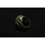 A continental yellow gold ring, the textured shank set with a cabochon apple green jade stone,