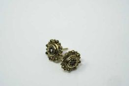 A pair of 9ct yellow gold antique style earrings each set with a small diamond,