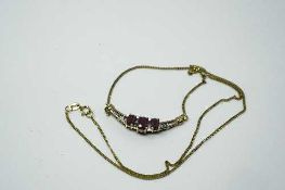 An 18ct yellow gold ruby and diamond pendant on chain,