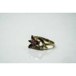 An 18ct gold ruby and diamond ring, size P/Q.