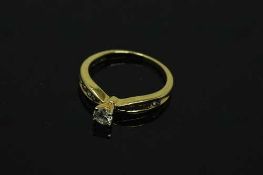A 14ct yellow gold diamond ring, the central stone approximately 0.