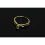 A 14ct yellow gold diamond ring, the central stone approximately 0.