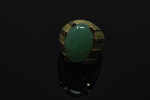 A continental yellow gold ring, the textured shank set with a cabochon apple green jade stone, - Image 2 of 2