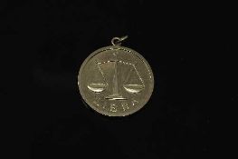 A 9ct gold disc pendant 'Libra', 15.8g.