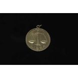 A 9ct gold disc pendant 'Libra', 15.8g.