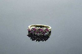 A 10ct gold ruby and diamond ring, approximately 0.9ct rubies, size N.