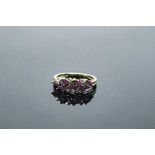 A 10ct gold ruby and diamond ring, approximately 0.9ct rubies, size N.