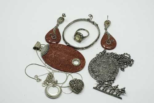 A collection of silver and white metal jewellery, coin on chain, ring etc.