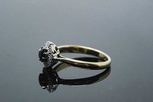 An 18ct gold diamond set sapphire ring, size Q.