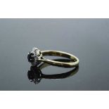 An 18ct gold diamond set sapphire ring, size Q.