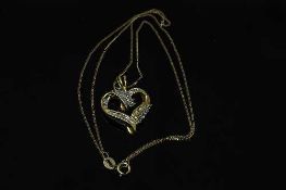 A 10ct yellow gold diamond set heart shaped pendant on yellow gold chain, approximately 0.2ct.