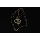 A 10ct yellow gold diamond set heart shaped pendant on yellow gold chain, approximately 0.2ct.