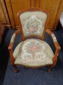 A stained beech salon armchair upholstered in tapestry fabric