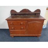 A Victorian pine sideboard fitted with cupboard and three drawers with shelf above