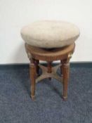 A late nineteenth century mahogany revolving piano stool