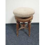 A late nineteenth century mahogany revolving piano stool