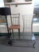 A metal glass topped coffee table together with a dining chair,