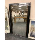 A black framed mirror