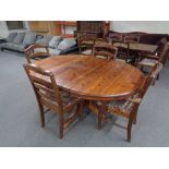 A circular pine ducal pedestal dining table and four chairs