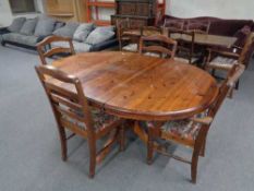 A circular pine ducal pedestal dining table and four chairs