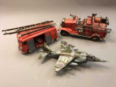 Two tin plate models of fire engines and another of a fighter jet.