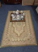 A tapestry rug together with a metal light fitting with glass drops,