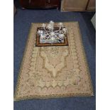 A tapestry rug together with a metal light fitting with glass drops,