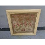 A nineteenth century framed alphabet sampler dated 1880