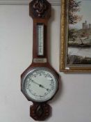 An Edwardian carved mahogany aneroid barometer