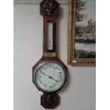 An Edwardian carved mahogany aneroid barometer