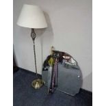 A frameless bevelled mirror, contemporary floor lamp with shade,