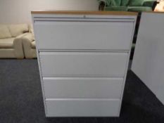 A four drawer metal document cabinet with oak effect top with key